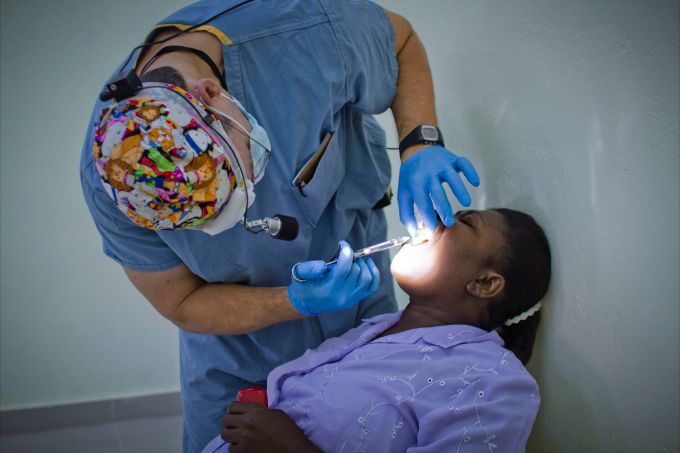 Dr. Williams administering an injection in a patient's mouth - Dental Mission in the Dominican Republic